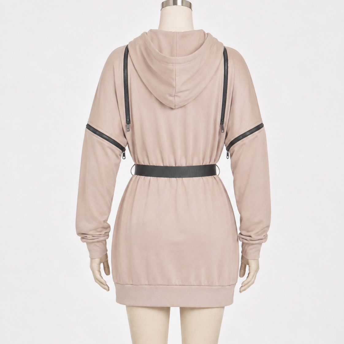 A light beige hooded sweatshirt dress displayed on a mannequin from the back, featuring black faux-leather shoulder straps and a matching black waist belt.